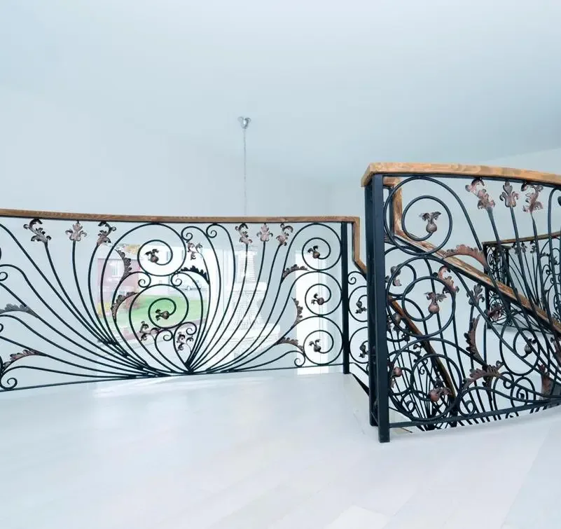 Decorative balustrade with scrolling metal pattern and wood-toned top rail